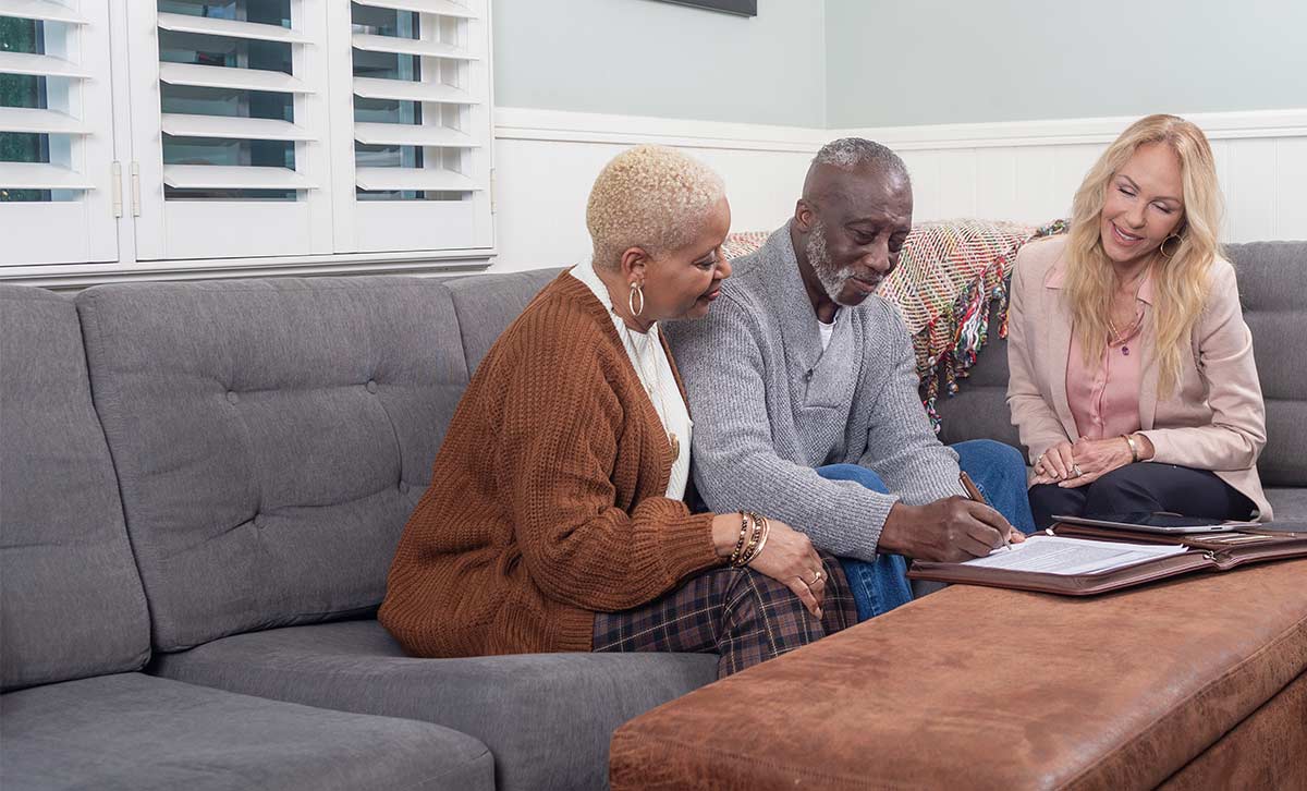 A retired couple and their financial professional discuss the performance of the retiree's registered index-linked annuity from TruStage™.
