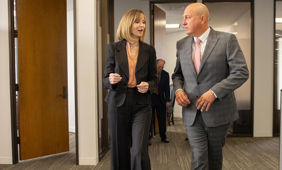 A businesswoman and businessman discussing selling TruStage insurance
